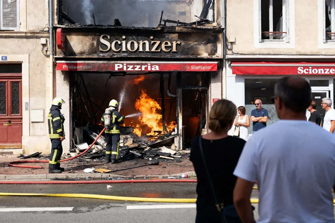 Pompiers éteignant l'incendie de la pizzeria Scionzier sous le regard des passants inquiets